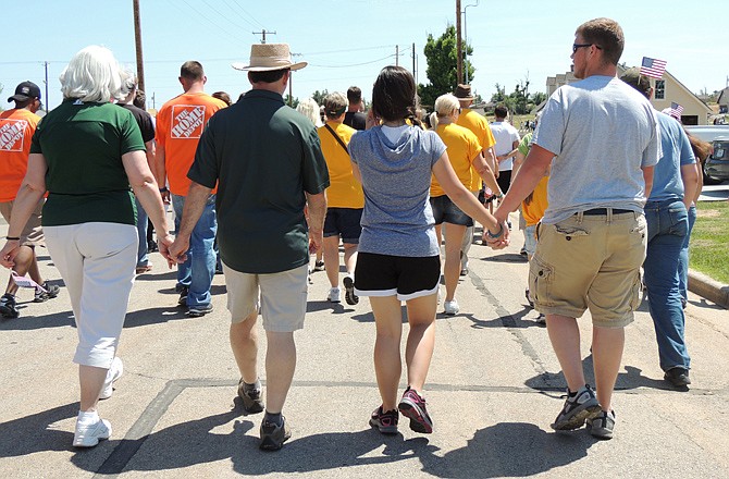 Participants in Joplin's Walk of Unity walk hand-in-hand Tuesday along the 3.7-mile path the May 22, 2011, tornado took.