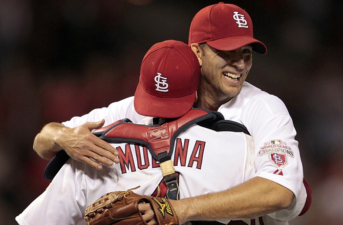 Cardinals starting pitcher Adam Wainwright (right) embraces catcher Yadier Molina after throwing a four-hitter against the San Diego Padres on Tuesday in St. Louis. The Cardinals won 4-0.