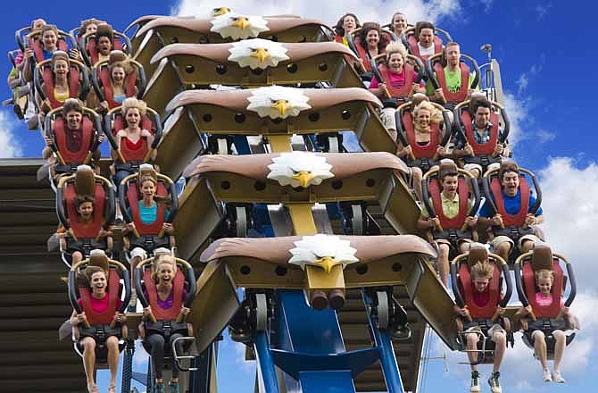 This undated photo provided by Dollywood shows riders on the Wild Eagle, a new 210-foot tall coaster that opened in March at the theme park in Pigeon Forge, Tenn. The coaster is one of a number of new attractions opening at theme parks around the country this season. 