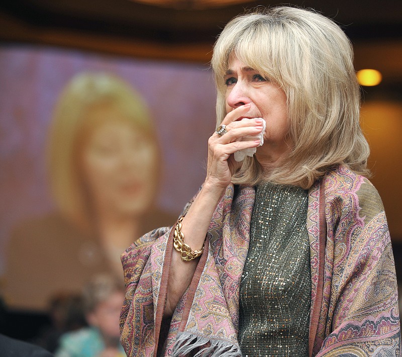 Local artist Sabra Eagan becomes very emotional Tuesday as she is introduced as the recipient of the Mrs. William H. Weldon Lifetime Achievement Award during the annual Zonta Yellow Rose luncheon