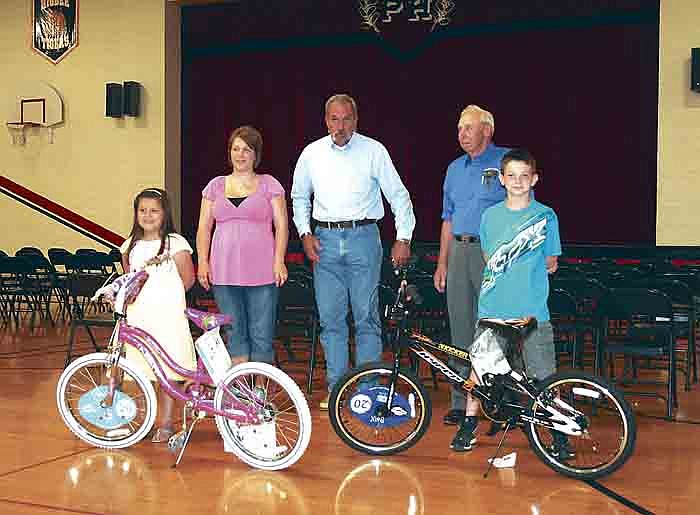 Winners of the Prairie Home School Bikes for Reading drawing held Friday at the PHS Elementary Awards Assembly, front row, from left, are kindergartener Caroline Rhode and fourth grader Clayton Pethan. Standing behind, from left, are Megan Alpers, owner of Split Ends, who purchased the girls' bike; Mason Tom Miller of Wallace Lodge #456; and mason Dorsey Alpers, who purchased the boys' bicycle. Students in grades K-6 had to read or be read to throughout the second semester of the school year to get their names in the drawing to win a bicycle. For every 50 minutes they read, their name was entered in the drawing. The Masonic Lodges of Boonville and Bunceton sponsor the program.