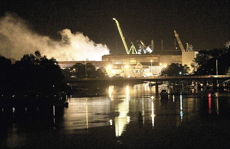 Smoke rises from a dry dock as fire crews respond Wednesday night to a fire on the USS Miami submarine at the Portsmouth Naval Shipyard on an island in Kittery, Maine. Four people were injured. 