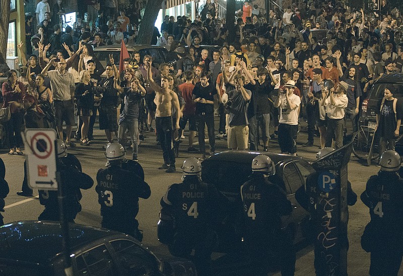 Protesters and riot police face-off during a march against tuition fee hikes Thursday in Montreal. Police arrested nearly 700 people overnight during a similar protest in Montreal.