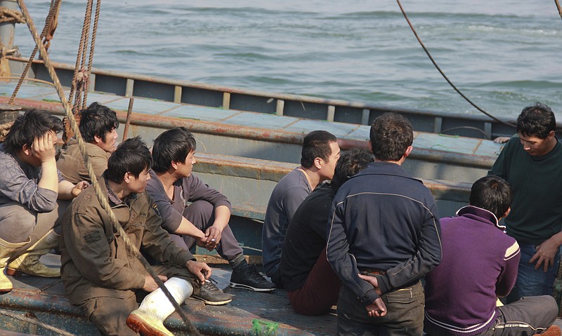 Chinese fishing crew members rest Monday on their boat on the way back home after 13 days in North Korean custody at a harbor in Dalian, China. China's leadership is hitting a rough patch with ally North Korea under its new leader Kim Jong Un.