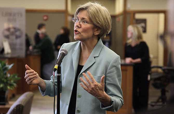 In this May 2, 2012 photo, Democratic candidate for the U.S. Senate Elizabeth Warren faces reporters during a news conference at Liberty Bay Credit Union headquarters, in Braintree, Mass. Warren addressed questions on her claim of Native American heritage. 