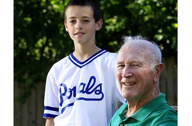 In this photo taken May 16, 2012, John Schmiedeler, right, poses for photos with his grandson Matthew in Kansas City, Mo. Schmiedeler was a part-time clubhouse manager for the visiting teams at the old Municipal Stadium in 1960, when he was 31-year-old math teacher. That year, Kansas City hosted the All-Star Game, featuring some of the all-time greats of the game making up the rosters.