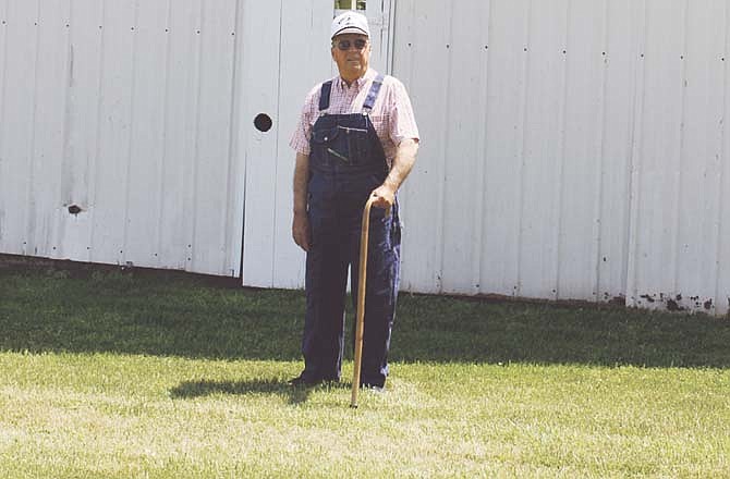 Lewis Baumgartner, known as the "World's Worst Farmer," stands in front of the barn on his property near Millersburg. The humor speaker, who suffered a stroke a few years ago, has added a motivational element to his program dealing with his recovery. 