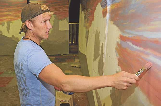 The eight panels of the 48-foot Old Munichburg mural are being painted by Jim Dyke in the basement of a 1940s movie theater (the old Coleman's building) on Dunklin Street in Jefferson City. In the 8 panels on the right, the viewer is standing at Madison Street looking west on Dunklin Street.