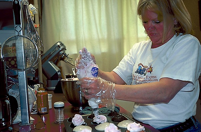 Kim Falter ices cupcakes at her business, Cupcake Express, on Rock Ridge Road.