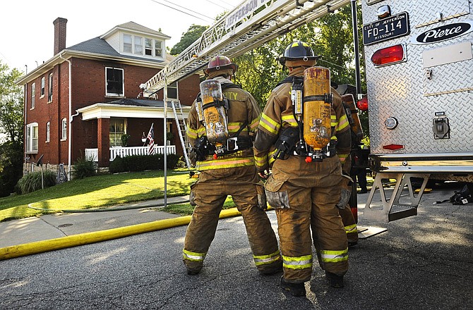Jefferson City firefighters respond to a house fire at 1001 W. High St. on Tuesday.