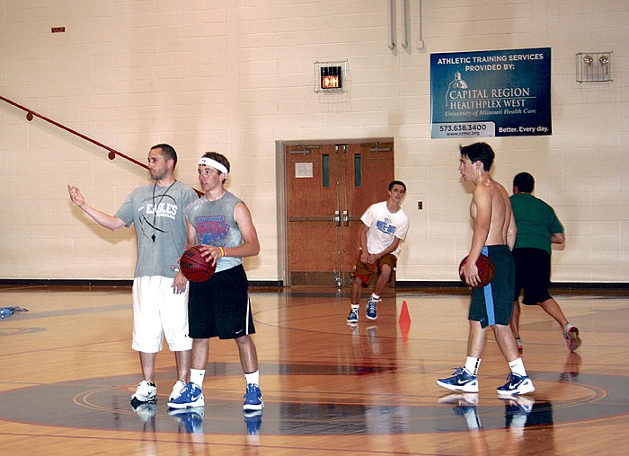 California High School Head Boys Basketball Coach Blair Scanlon, at left, works with participants of the annual California Pinto Basketball Camp Thursday afternoon at CHS.