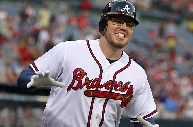 Atlanta Braves first baseman Freddie Freeman reacts after hitting a solo home run in the first inning of a baseball game against the St. Louis Cardinals, Wednesday, May 30, 2012, in Atlanta. Freeman, wearing new eyeglasses, was able to return to the lineup after missing several games with vision problems. 