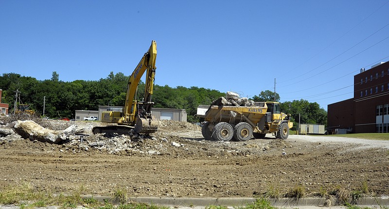 Workers clear a lot on the north side of Chestnut Street near the State Health Lab and across from the former Missouri State Penitentiary.