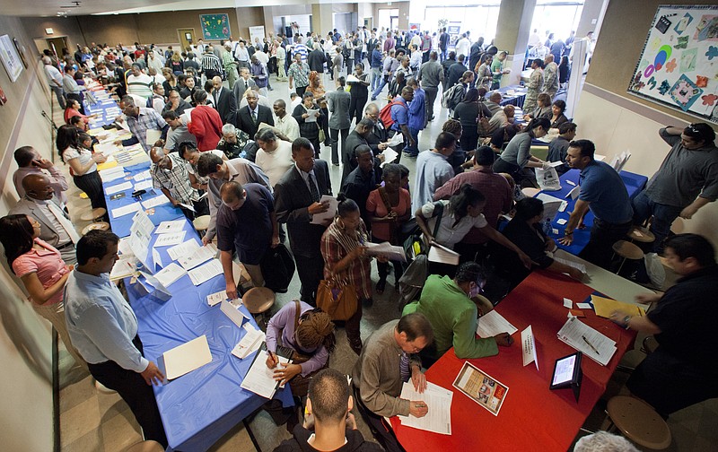 Job seekers gather for employment opportunities Thursday at the 11th annual Skid Row Career Fair at the Los Angeles Mission in Los Angeles. This year's employment slowdown is an improvement on last year's.