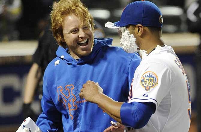 New York Mets' Justin Turner, left, reacts after hitting starting pitcher Johan Santana with a shaving cream pie after Santana threw a no-hitter against the St. Louis Cardinals in a baseball game on Friday, June 1, 2012, at Citi Field in New York. The Mets won 8-0.