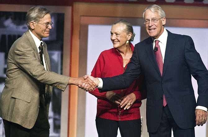 Jim Walton, left,, Alice Walton, center, and Robson Walton, right, greet each other during the beginning of the Walmart Stores Inc. shareholders' meeting in Fayetteville, Ark., Friday, June 1, 2012. The three siblings are the children of the late Sam Walton, founder of Walmart.