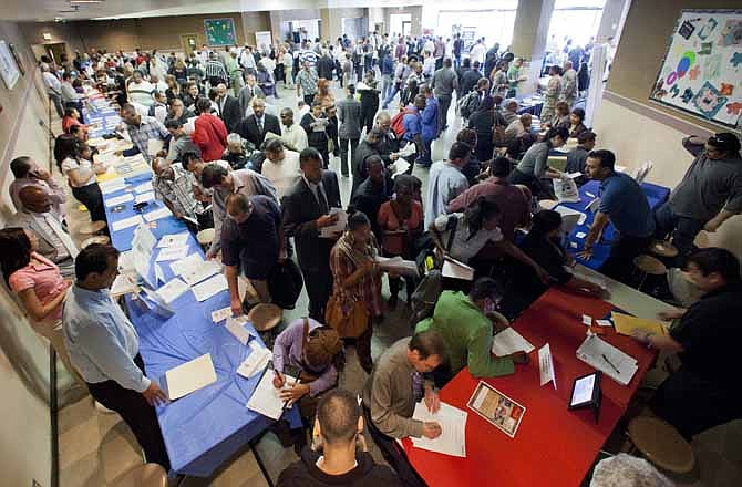 In his Thursday, May 31, 2012 file photo, job seekers gather for employment opportunities at the 11th annual Skid Row Career Fair at the Los Angeles Mission in Los Angeles. Business has picked up. Yet American companies are too nervous to step up hiring. 