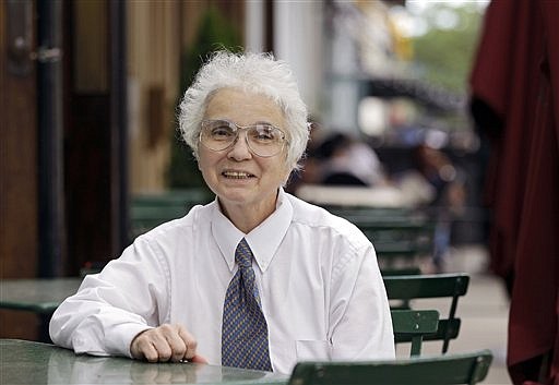 Waitress Ginny Hopkins sits at a table outside Johnny's Downtown restaurant in Cleveland, Ohio, where she works, Saturday, June 2, 2012. Hopkins recently received a federal tax refund check for nearly $435,000, which she returned to the local IRS office. She is still awaiting her more modest refund from 2011.