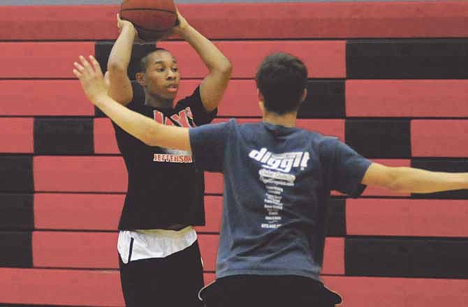 Jefferson City's Harold Robertson looks to pass the ball during the Jays' basketball camp last week at Fleming Fieldhouse.