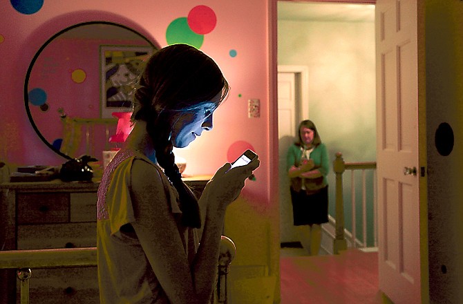 Anna Schiferl, foreground, texts her mother, Joanna, as they pose for a photograph in their LaGrange, Ill., home.