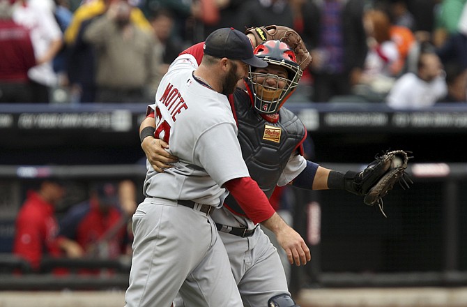 Cardinals catcher Yadier Molina celebrate with relief pitcher Jason Motte after Monday afternoon's 5-4 victory over the Mets in New York.