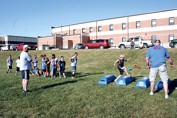 Participants of the annual Junior Pinto Football Camp held May 29-31 at the California Middle School practice field work hard at work May 29 brushing up on basic fundamentals.