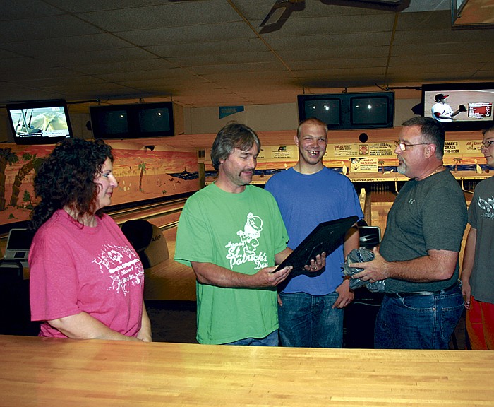 California Lanes owner Rob Rimel, center, is presented a special show of appreciation from Russellville Special Olympics Bowling Coaches Trish Roth, at left, and Bob Roth, far right, along with the Special Olympics bowlers, following their last practice of the 2012 season.