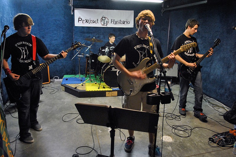 Project Hysteria practices some of their favorite tunes including Green Day's "Brain Stew" and "Wild Thing" Friday evening at bandleader Austin Perkins' basement studio before hitting Luby's stage this Friday night at Hot Summer Nights on Bagnell Dam Strip in Lake Ozark. 