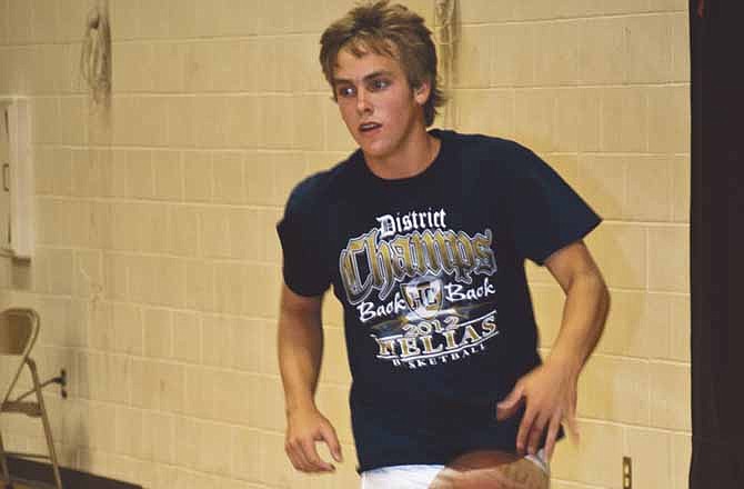 Jared Bentlage dribbles out after taking a rebound at the Helias basketball camp.