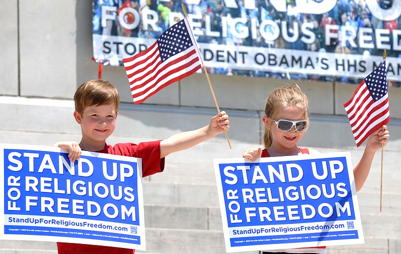 Asher Newlon, left, and Savannah Moehlman, both 7, stand on the steps for pictures by proud parents after the conclusion of Friday's Stand Up for Religious Freedom Rally at the Capitol. Newlon's mom, Gina, was one of the event's speakers. 