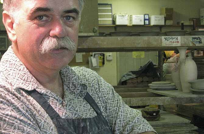 This June 7, 2012, photo shows artist Steve Ayers in his shop in Hannibal, Mo. When Ayers opened his pottery shop in 1985 he was about the only artist in the riverfront town known mostly for its favorite son, Mark Twain. Twain still is the main draw for the half-million tourists who visit Hannibal each year, but now they get a bonus: A growing number of artists, many of national and international repute.