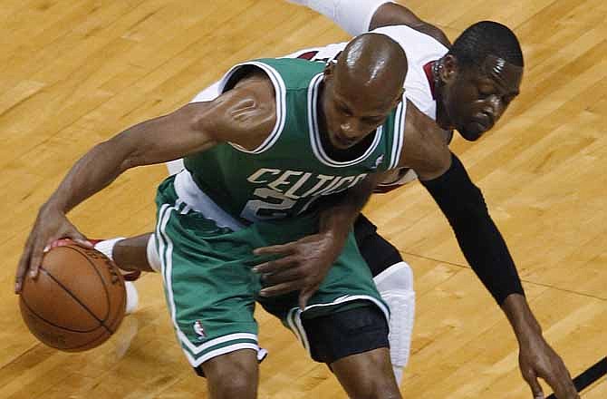 Boston Celtics' Ray Allen (20) defends the ball from Miami Heat's Dwyane Wade during the first half of Game 7 of the NBA basketball playoffs Eastern Conference finals, Saturday, June 9, 2012, in Miami. 