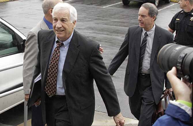 In this June 5, 2012 file photo, former Penn State University assistant football coach Jerry Sandusky, left, arrives with his attorney Joe Amendola, right, for the first day of jury selection for his trial on child sexual abuse charges, in Bellefonte, Pa. In wake of the Sandusky scandal, questions have arisen about the effectiveness of laws requiring people to report suspected abuse. 
