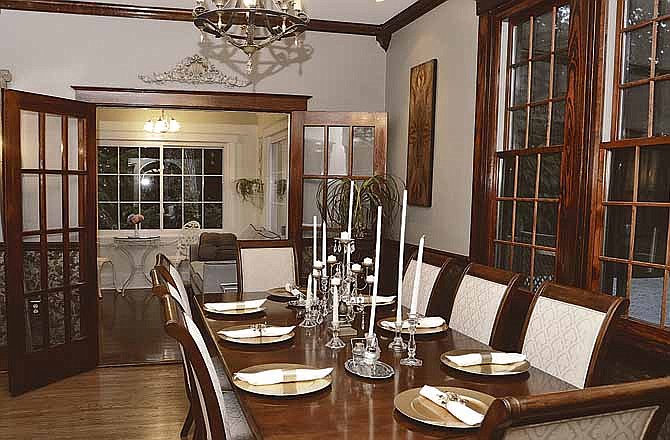 Kelsey and Jeremy Hilburn have spent the last four years remodeling and updating their Moreland Avenue home. The formal dining room opens into the newly created sun room, where the couple spends much of their time at home. 