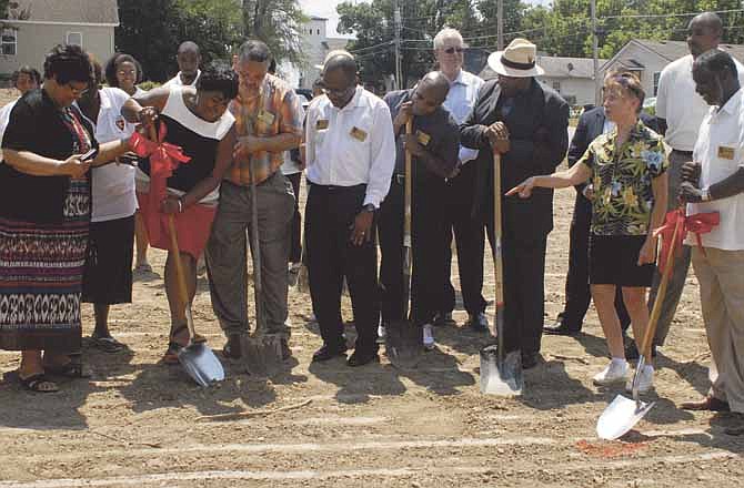 The congregation of Quinn Chapel AME watches as the Rev. Cassandra Gould pushes the first shovel in at the ground-breaking ceremony Saturday in Jefferson City at their future home at the corner of East Miller and Lafayette streets. 