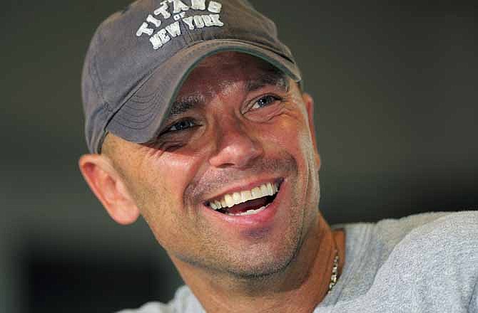 This June 1, 2012 file photo shows Country singer Kenny Chesney at a news conference to promote his "Brothers of the Sun" concert tour in Tampa, Fla. Kenny Chesney and Jonathan Demme will collaborate on the next installment of the "American Express Unstaged" music series on June 20.
