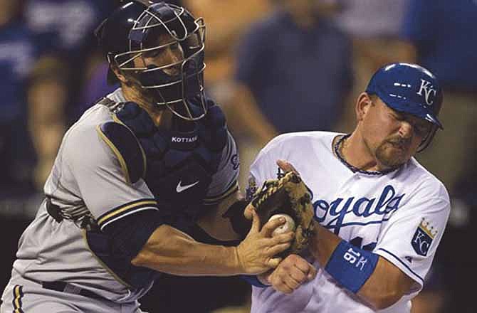 Milwaukee Brewers catcher George Kottaras, left, tags out Kansas City Royals' Billy Butler (16) during the sixth inning of a baseball game at Kauffman Stadium in Kansas City, Mo., Wednesday, June 13, 2012. Butler was trying to score from second base on a single by teammate Jeff Francoeur.
