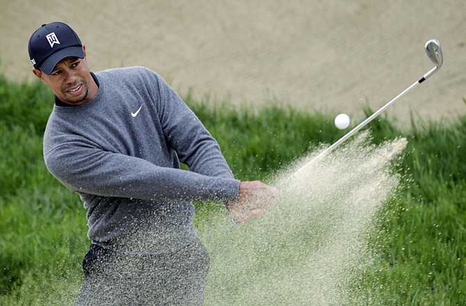 Tiger Woods hits out of a bunker on the second hole during Wednesday's practice round for the U.S. Open at the Olympic Golf Club in San Francisco. 