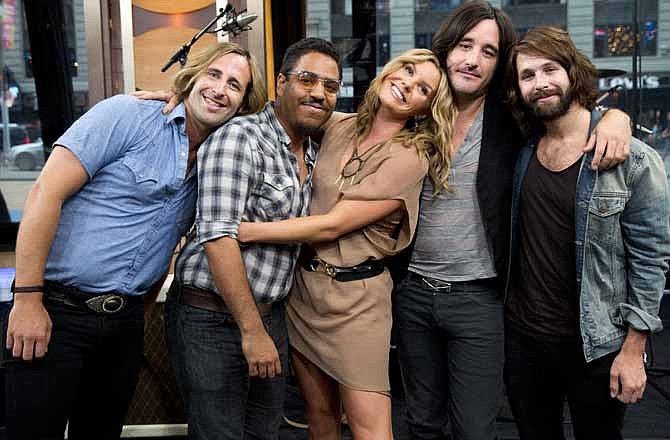 This June 12, 2012 photo shows members of Grace Potter and the Nocturnals, from left to right, Matt Burr, Michael Libramento, Grace Potter, Scott Tournet and Benny Yurco in New York. Potter isn't the type to do what people expect; she's more interested in following her heart. That's why the band's latest, "The Lion, The Beast, The Beat," ramps up the rock quotient considerably from its last self-titled release in 2010. 