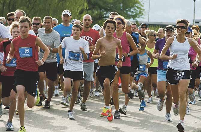 Runners take off during the annual YMCA Father's Day 5K walk/run Saturday morning at the Jefferson City Memorial Airport.
