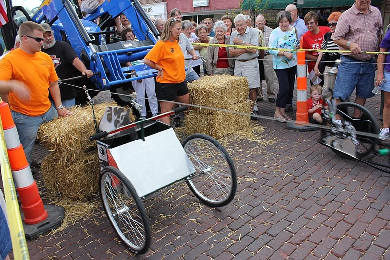 The Ovid Bell Press mule, right, sprints to catch up with Callaway Bank's, but to no avail. Callaway Bank mauled the competition, winning both the Callaway Cup and the SERVE, Inc. fundraiser race.