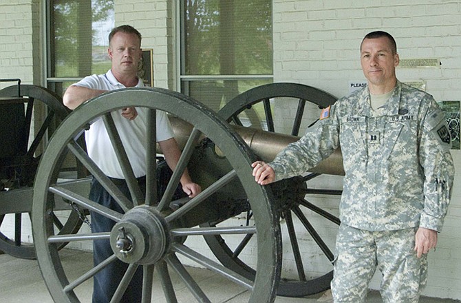 Museum director Charles Machon, left, and Capt. Alan Brown, historian, stand next to a 6-pounder cannon from the Civil War. The cannon and other items from Missouri's military history will soon be displayed inside a larger facility.