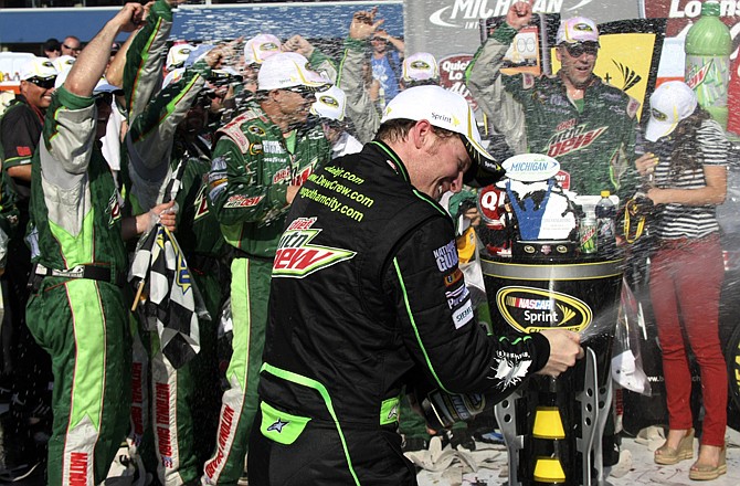 Dale Earnhardt Jr. celebrates Sunday afternoon after winning the Quicken Loans 400 at Michigan International Speedway in Brooklyn, Mich.