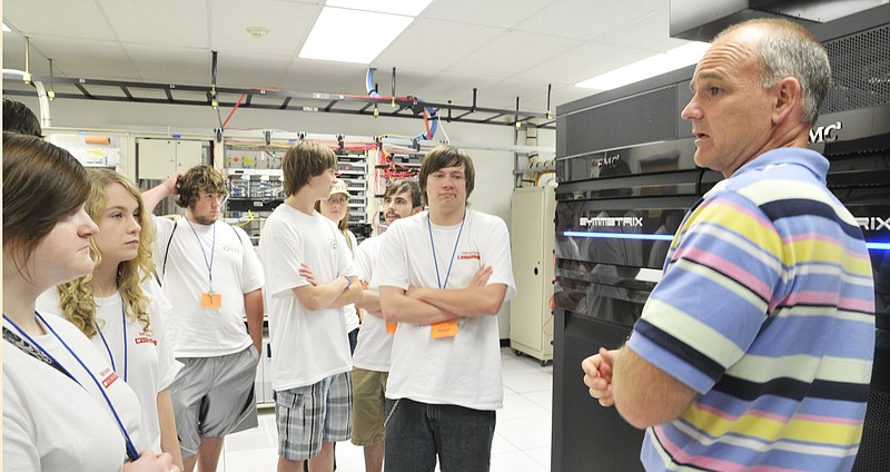 Jerry Kolb, manager of systems and operations for Central Technology Services, gives a tour Tuesday to technologically inclined students from around the state who are spending several days at Linn State Technical College learning about opportunities at CPoD or Computer Professions on Demand. Commonly called "computer camp,' students are introduced to computer programming and script writing, and were able to tour a number of sponsor businesses to see the need and use of technology. Students are Cara Strunk, left, Ashley Painter, second, and at right is Nathan Gelina. 