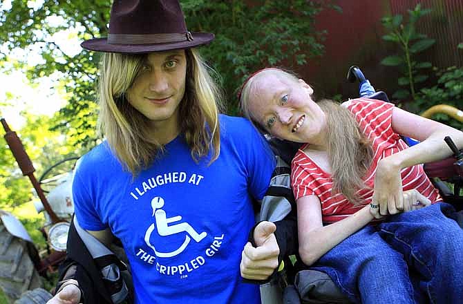Ally Bruener, right, poses for a photograph with friend Forest Thomer at her Alexandria, Ky. home on June 13, 2012. Thomer, who says he was charged with disorderly conduct after using the word "crippled" to promote her comedy act claims Cincinnati police violated his free speech rights, and the comedian, who has muscular dystrophy, agrees.
