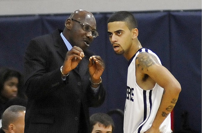 Lincoln coach John Redmond talks with Trent Littlejohn during a game last season at Jason Gym.