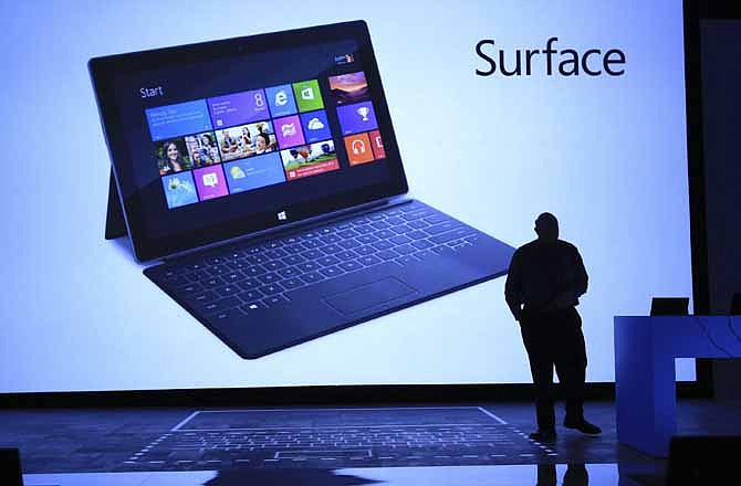 In this photograph taken by AP Images for Microsoft, Steve Ballmer, Microsoft Chief Executive Officer, reveals Surface, a new family of PCs, for Windows, Monday, June 18, 2012, in Los Angeles.