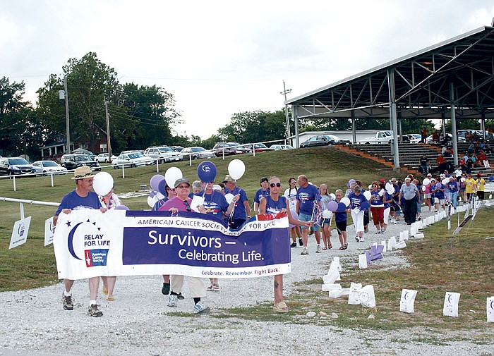 The 12th Annual Moniteau County Relay for Life was held Friday through Saturday at the Moniteau County Fairgrounds, California. Above, cancer survivors walk the Survivor Lap during the opening ceremony of the event.