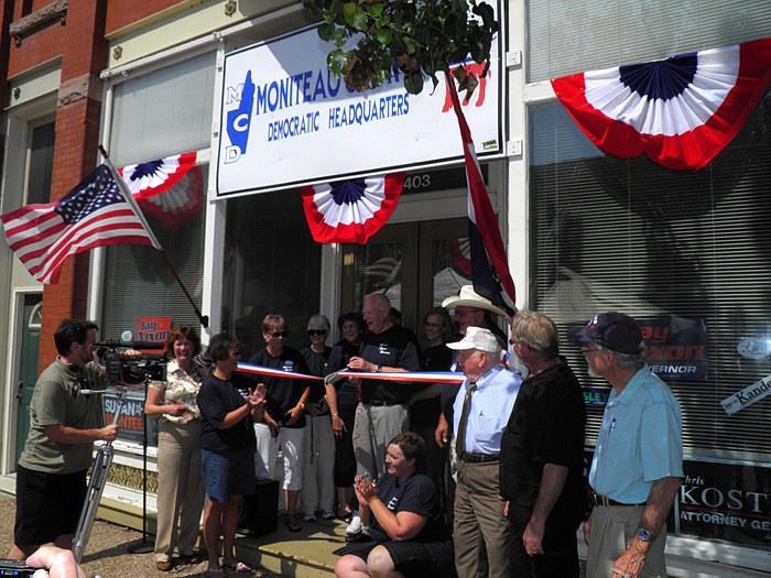 Local supports gather around Gail Hughes, who get ready to cut the ribbon on the new Moniteau County Democrats Headquarters located at 403 North High Street, California, donated by John and Patricia Kay at the ceremony held Saturday, June 16.