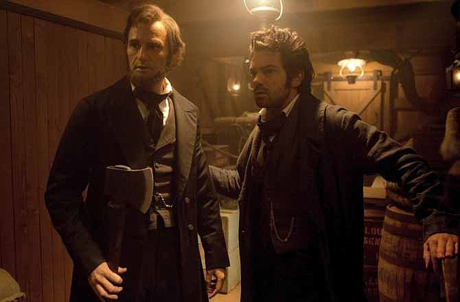 This film image released by 20th Century Fox shows Benjamin Walker portraying Abraham Lincoln, left, and Dominic Cooper portraying Henry Sturgis in a scene from "Abraham Lincoln: Vampire Hunter." 